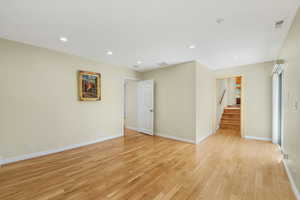 Primary Bedroom entry/Study featuring light hardwood floors, deck access, and recessed lighting.