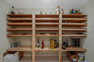 Wine cellar featuring baseboards and light tile patterned flooring