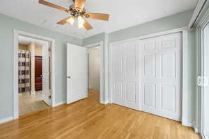 Guest Suite with light hardwood flooring, a ceiling fan, and en suite full bathroom