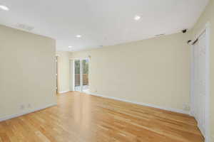 Primary Bedroom entry/Study featuring light hardwood floors, deck access, and recessed lighting.