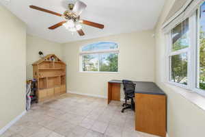 Home office featuring Travertine tile floors and both city and mountain views