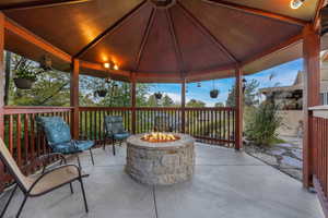 View of patio with a gazebo and an outdoor fire pit