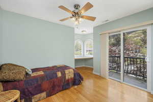 West Bedroom featuring hardwood floors, built in desk with 270* city and mountain views, and a private balcony