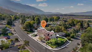 Aerial view of residential area featuring mountains and property boundaries highlighted