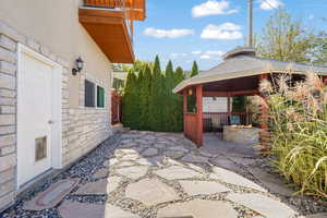 View of patio / terrace featuring a gazebo and a fire pit
