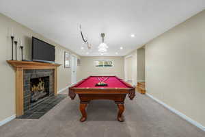 Playroom with billiards, a tile fireplace, recessed lighting, and carpet
