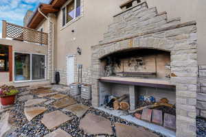 View of patio / terrace featuring an outdoor stone fireplace