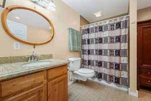 Full bath featuring vanity, a shower with curtain, and light tile patterned flooring