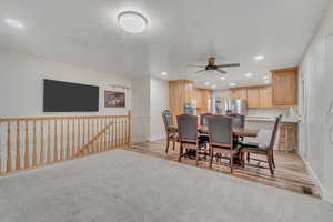 Dining area featuring a ceiling fan, light colored carpet, recessed lighting, and light wood-type flooring