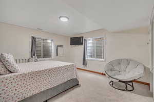 Bedroom featuring carpet flooring and baseboards