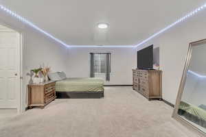 Bedroom featuring light colored carpet