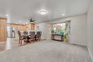 Dining area featuring ceiling fan, light colored carpet, and recessed lighting