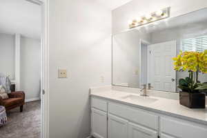 Bathroom featuring vanity and dark colored carpet