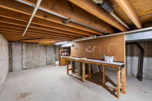 Unfinished basement with a workshop area