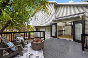 Wooden deck featuring an outdoor fire pit