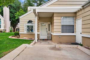 Front door showing dedicated parking space and entrance to garage.