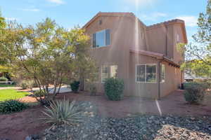 View of side of home with a tile roof and stucco siding