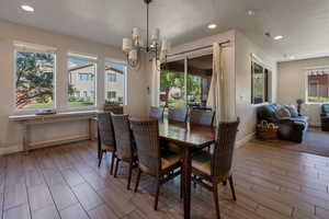 Dining room with recessed lighting, wood tiled floors, and a chandelier