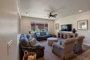 Living area with recessed lighting and ceiling fan