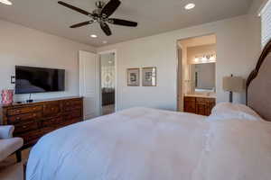 Carpeted bedroom featuring recessed lighting, a ceiling fan, and ensuite bathroom