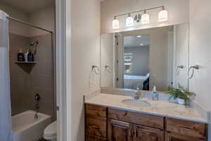 Ensuite bathroom featuring shower / bath combo and vanity