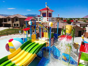 Community play area with a mountain view and a residential view