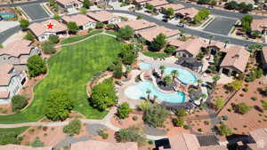 Aerial view of property and surrounding area with a pool area and nearby suburban area