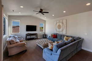 Living room featuring carpet floors, vaulted ceiling, recessed lighting, and a ceiling fan