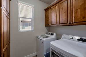 Laundry room featuring cabinet space and washer and dryer