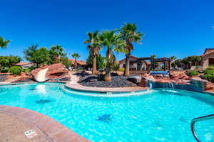 Community pool featuring a patio and a water slide