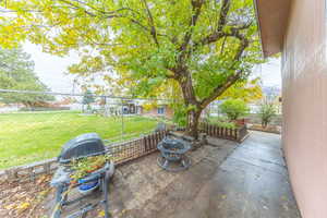 Fenced backyard with a fire pit