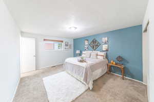 Carpeted primary bedroom with ensuite