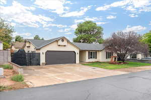 Single story home featuring concrete driveway, a garage, and roof with shingles