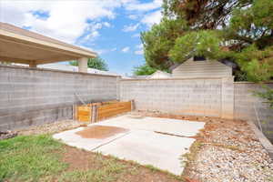 Fenced backyard with a patio