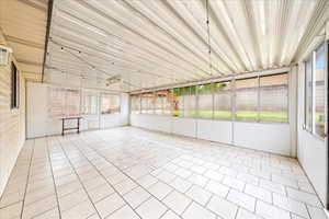 Unfurnished sunroom with tile patterned flooring