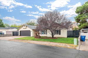 View of front of home featuring concrete driveway and an attached garage