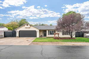Ranch-style home featuring concrete driveway, a garage, and a shingled roof