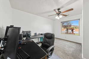 Office featuring light carpet, a textured ceiling, and a ceiling fan