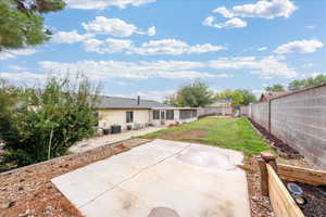 Rear view of property featuring a patio and a fenced backyard