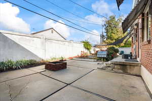 Fenced backyard with a patio area and a fire pit