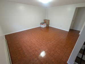 Spare room with baseboards and a baseboard radiator