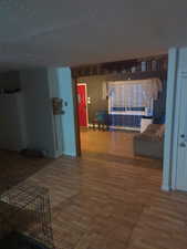 Living area featuring wood finished floors and a baseboard heating unit