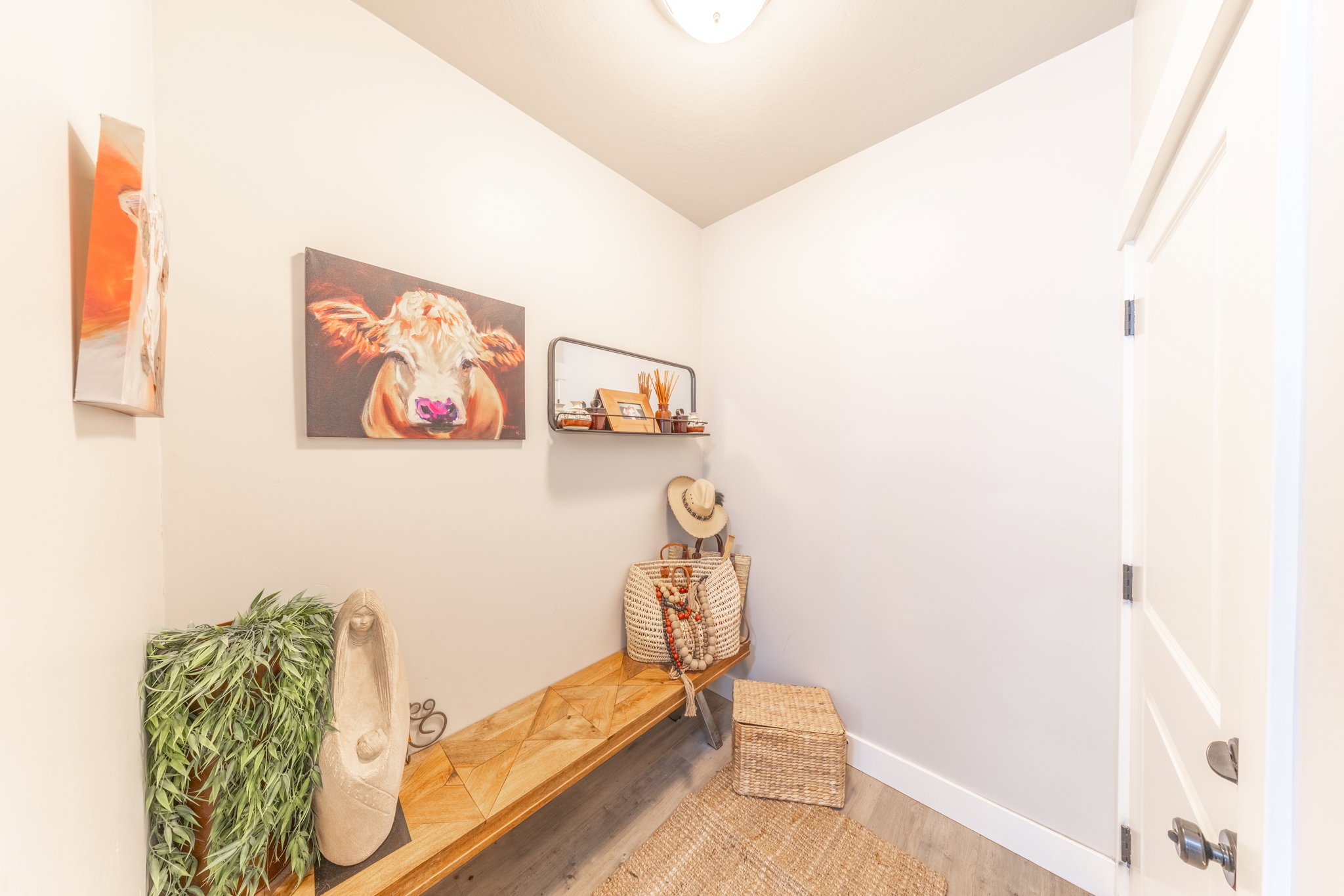 Mudroom with wood finished floors and baseboards