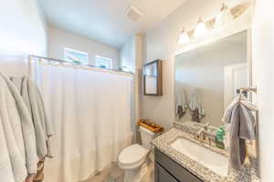 Bathroom with vanity and shower / bath combination with curtain