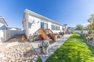 Back of property with a fenced backyard and a patio area