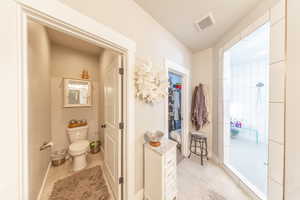 Bathroom featuring walk in shower and light tile patterned floors