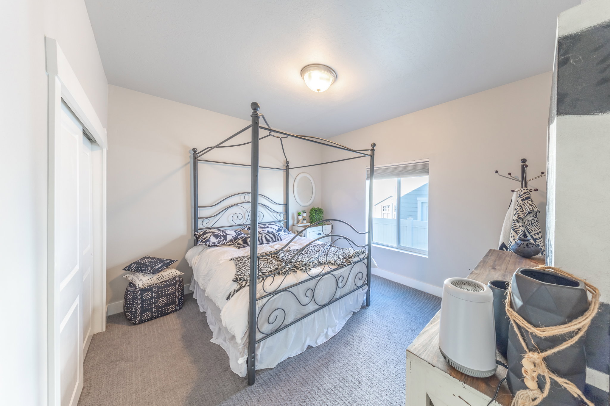 Carpeted bedroom with baseboards and a closet