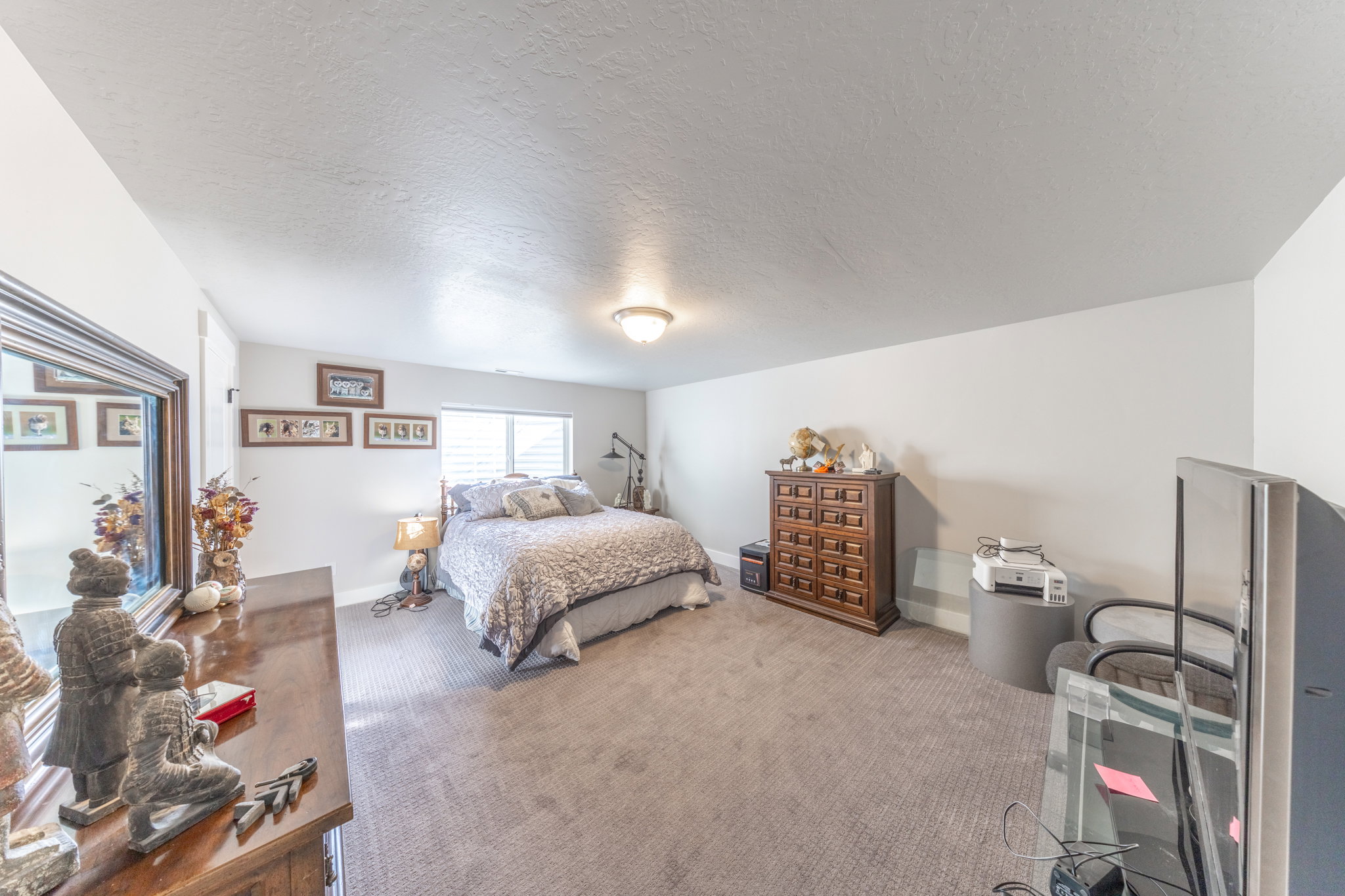 Bedroom featuring carpet and a textured ceiling