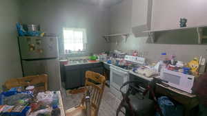 Kitchen with white appliances and open shelves