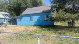View of front of home featuring a shingled roof and stucco siding